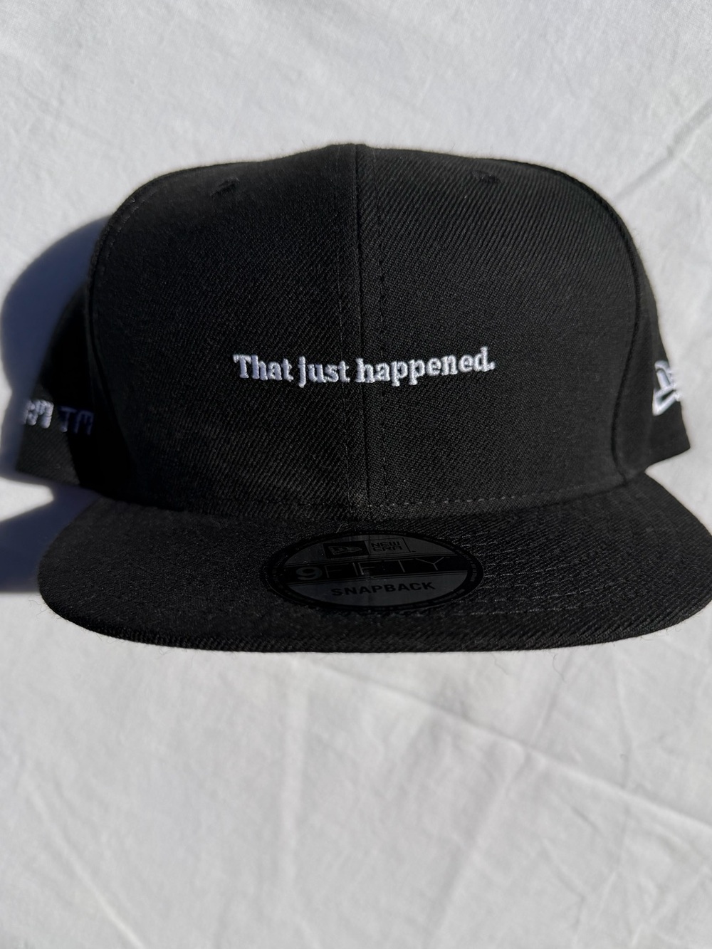 New Era Black Snapback Hat with White "That just happened." Embroidery